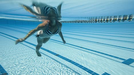 Woman-swimming-in-the-poolin-the-olympic-Swimming-pool-view-from-under-water